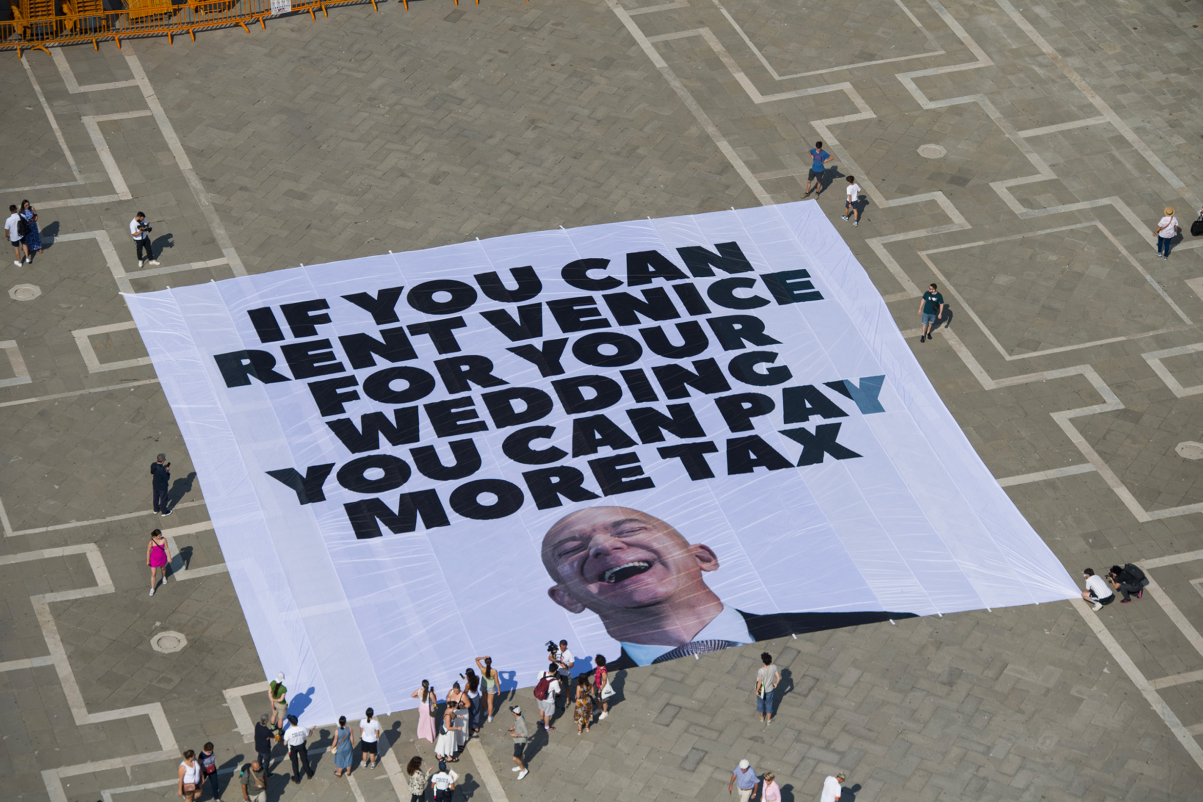 venice greenpeace banner against bezos wedding pay more