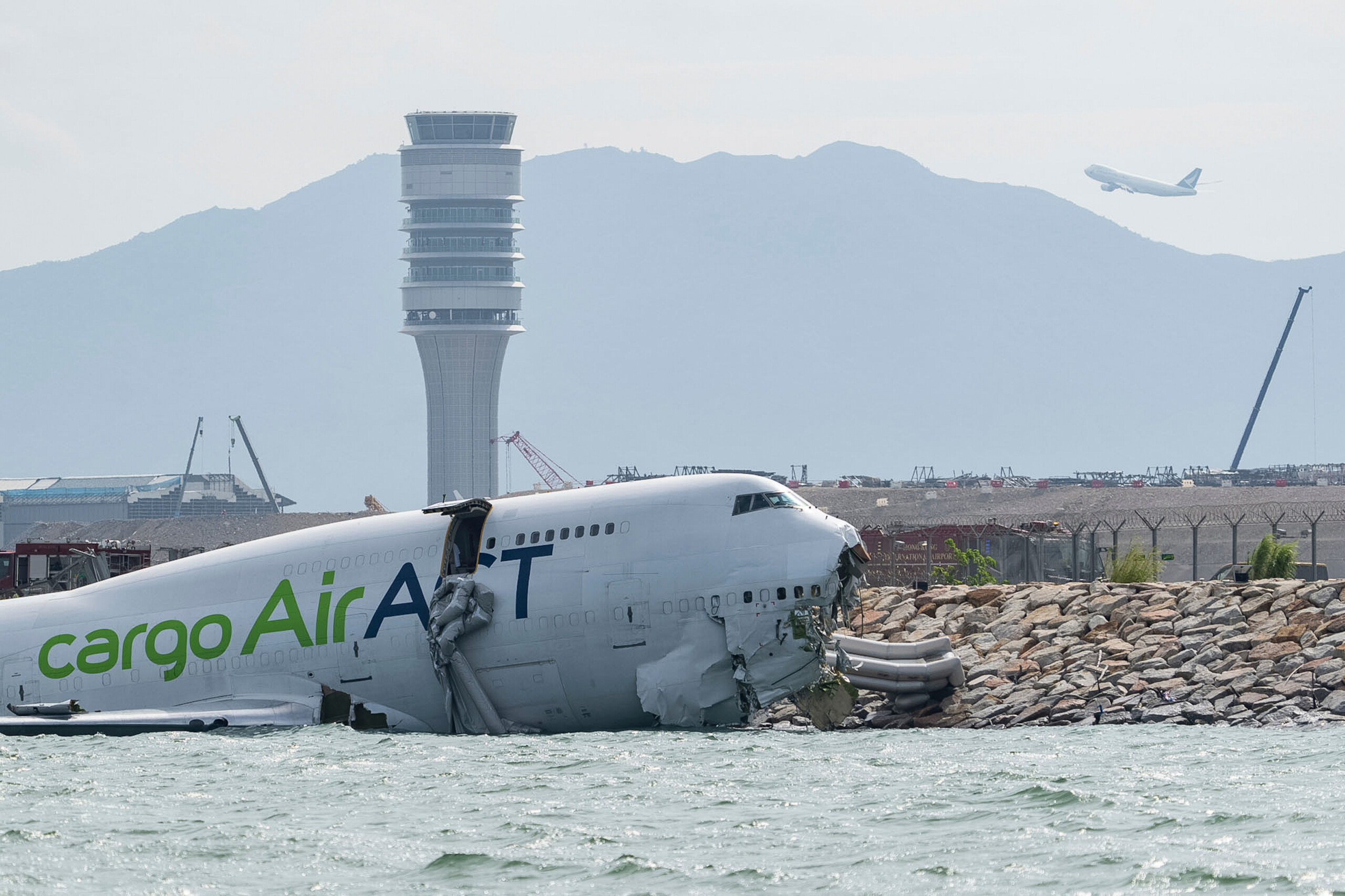 hong kong cargo plane skids off runway two dead scaled