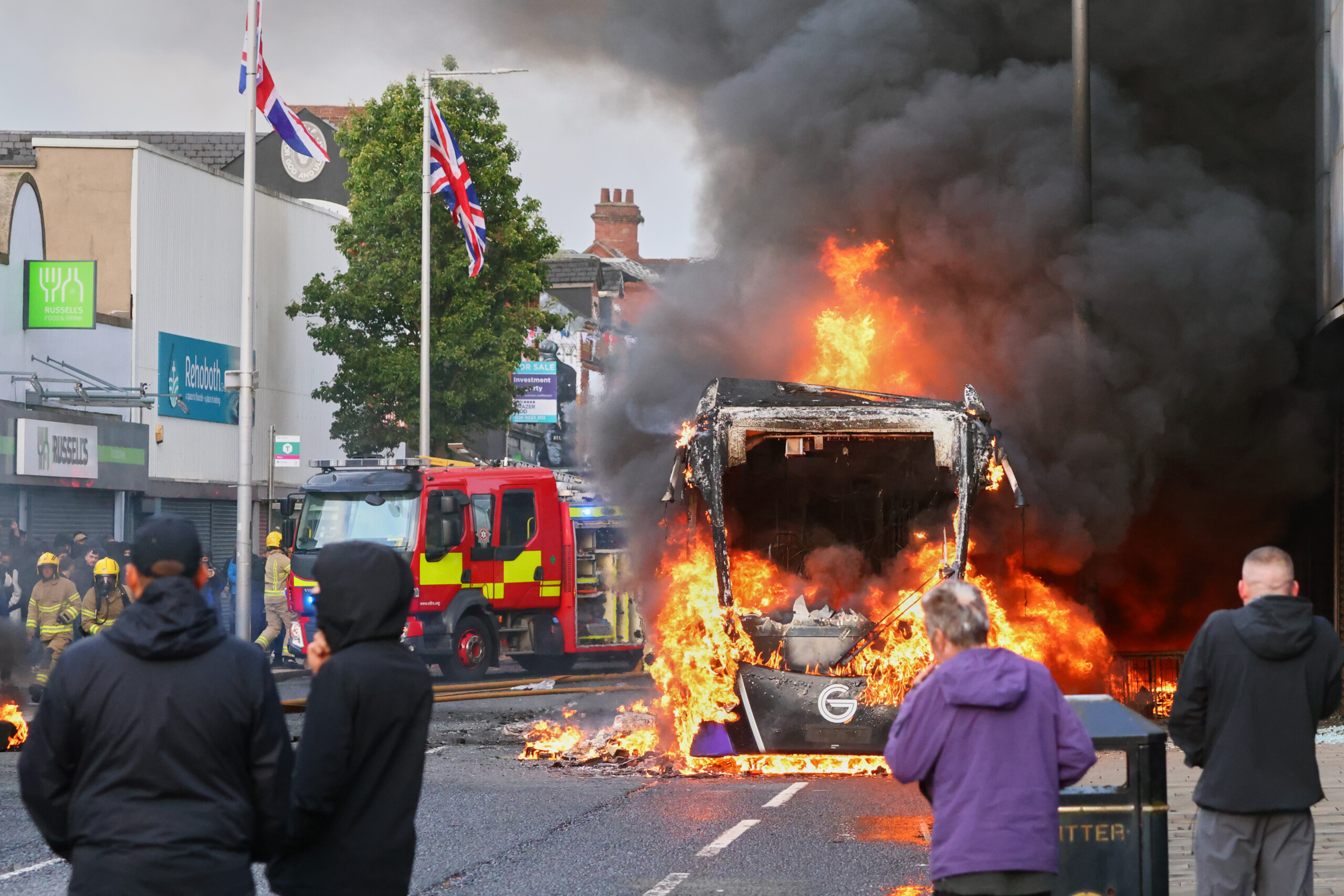 northern ireland anti migrant protests buses and rubbish bins set alight in belfast scaled
